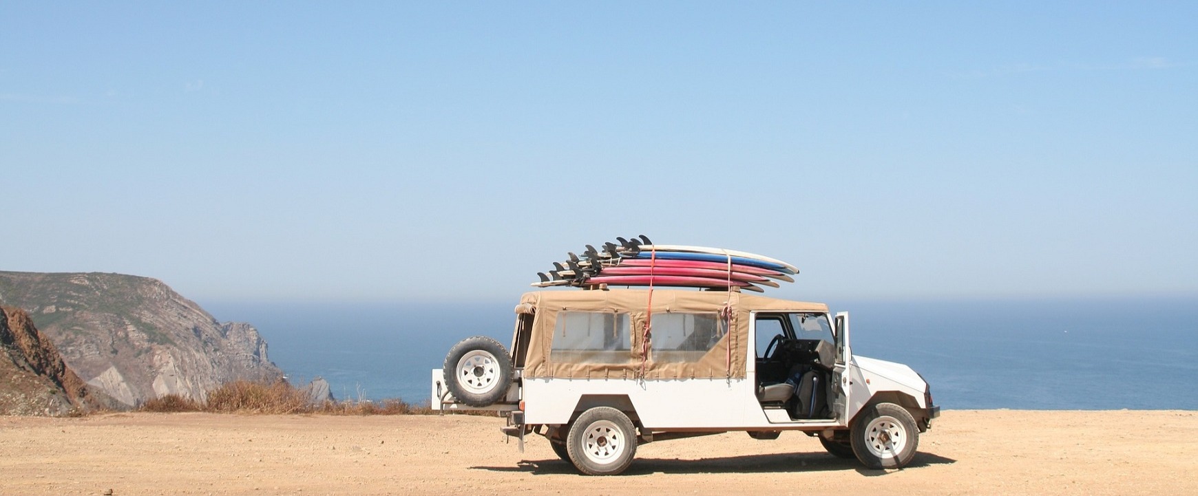 bel jeep na peščeni plaži